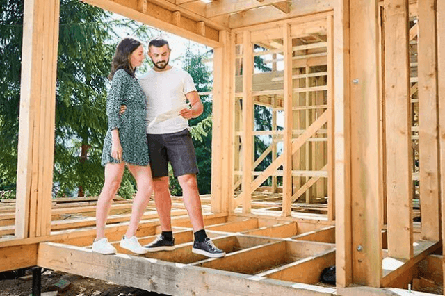 A couple over looking the progress of their new addition to their home