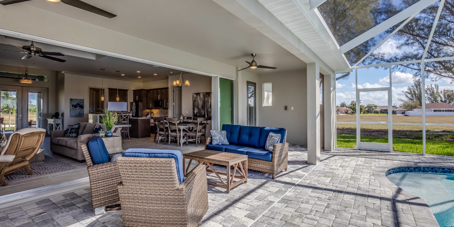 Outdoor living area by an inground pool