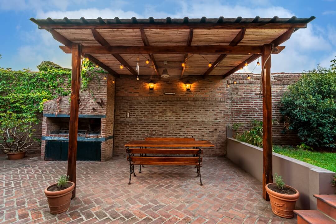 Outdoor living space with a covered pergola and a kitchen area